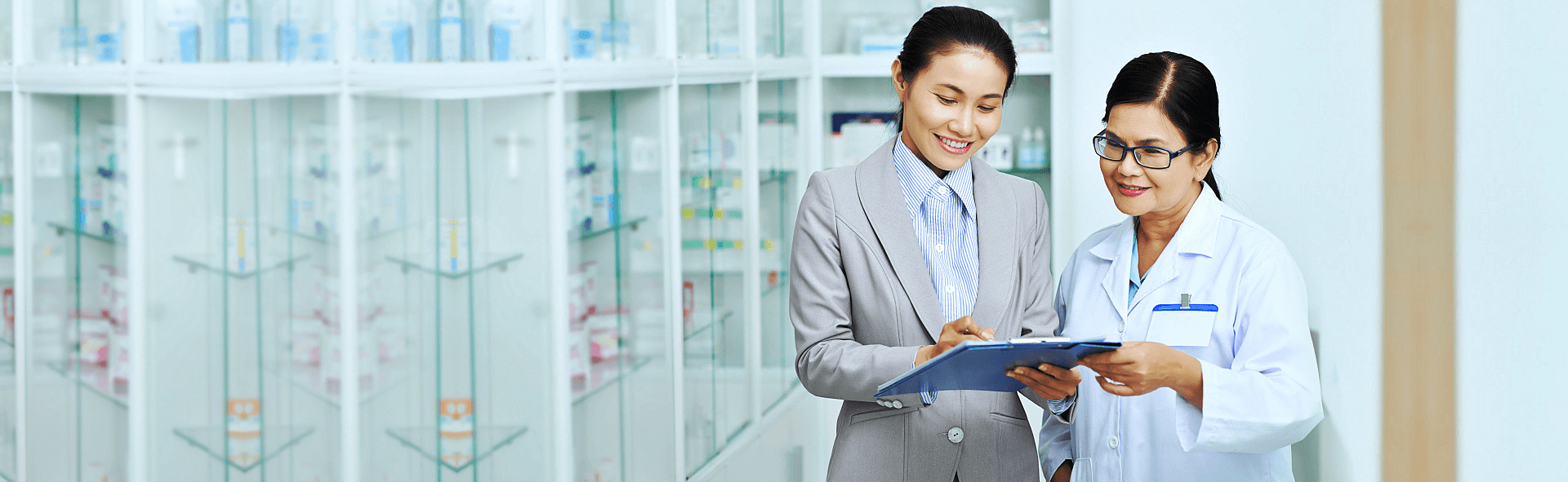 pharmacist and a patient looking at records